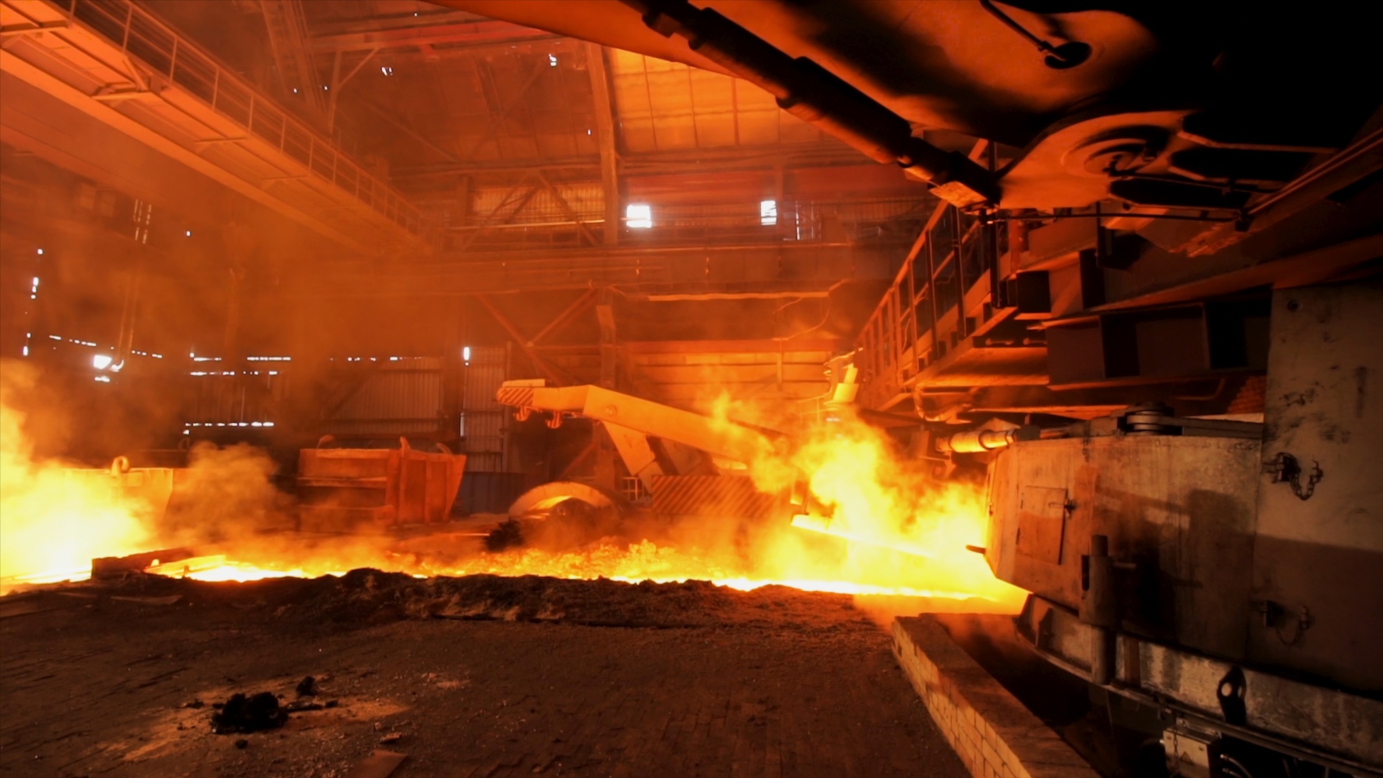 Hot steel being poured to the chute at the steel plant, heavy industry concept. Stock footage